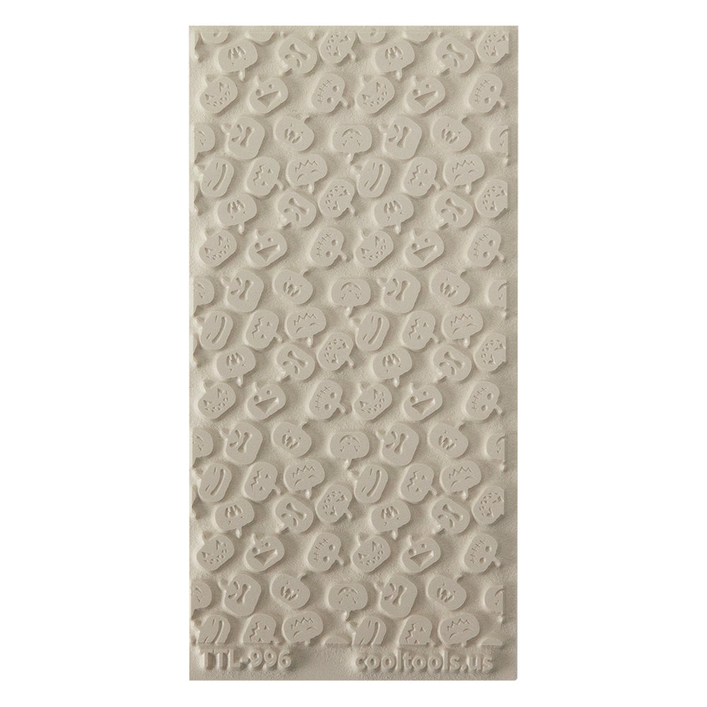 Texture Tile - Carved Pumpkins. Beige Texture Tiles are flexible, washable and can be used with any soft clay. Spritz with CoolSlip or dust on Dry Powder Release for stick-free impressions when using metal clay and polymer clay.