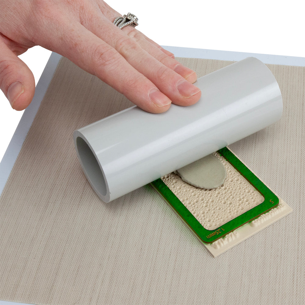 hand rolling out metal clay with mini wonder roller, green mini rolling frame with texture tile