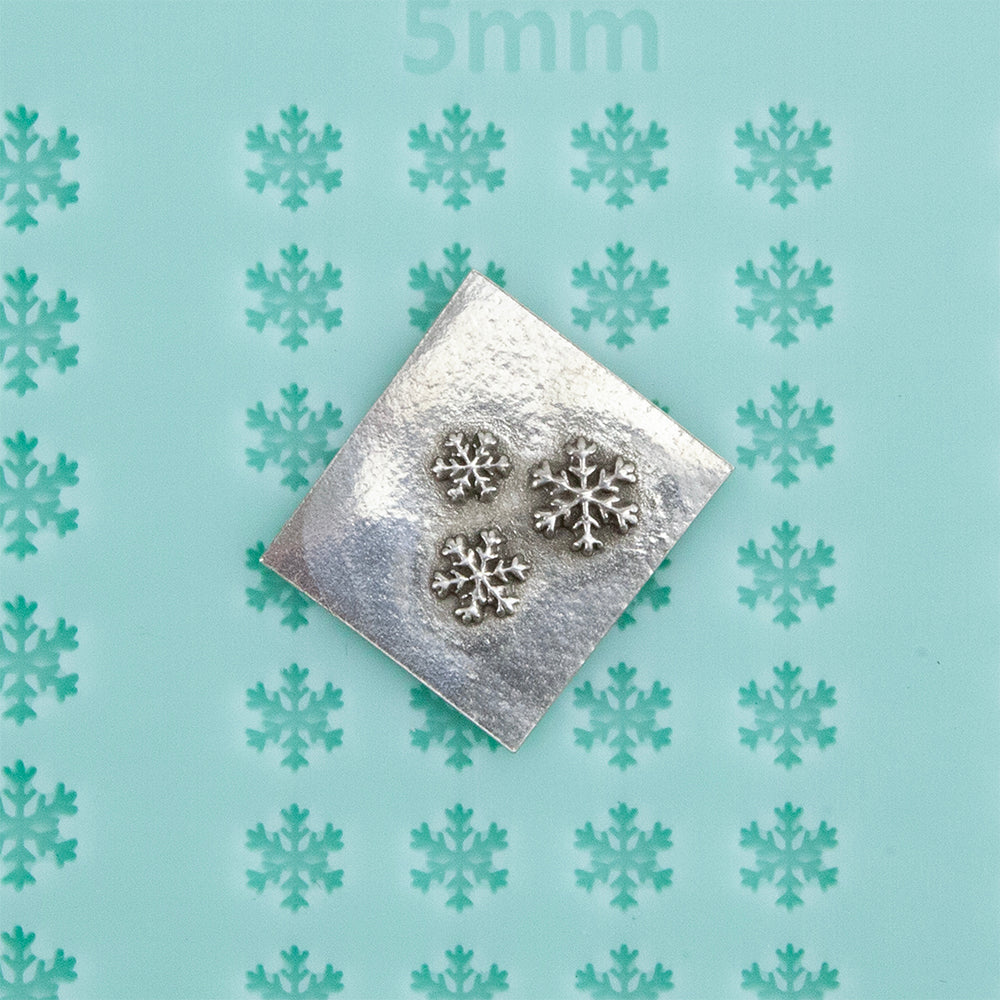 Finishing Touches Mold - Snowflake 1 with silver sample -Cool Tools Finishing Touches are silicone molds specially designed to create precise and repeatable shapes and adornments for metal clay and polymer clay. Each mold is perfectly calibrated for jewelry and jewelry component