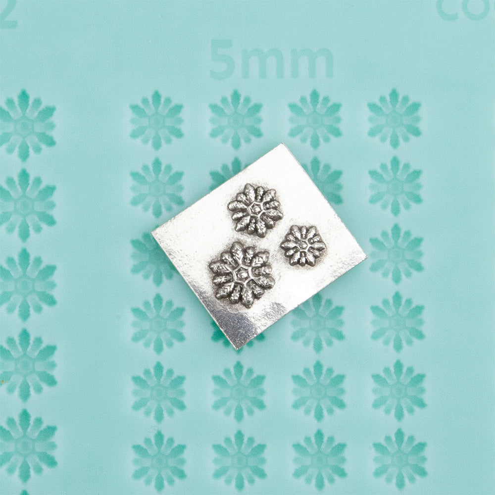 Finishing Touches Mold - Snowflake 2 with silver sample - Cool Tools Finishing Touches are silicone molds specially designed to create precise and repeatable shapes and adornments for metal clay and polymer clay. Each mold is perfectly calibrated for jewelry and jewelry components