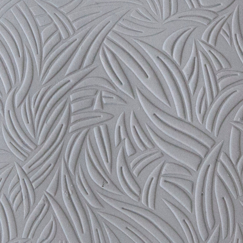 sample in clay of Mega Texture Tile - Grass Embossed. Use to impress texture in soft clays. Mega Texture Tiles are perfect for projects both large and small. Mega Tiles measure 9-1/4" x 6" and are about 7 times larger than Texture Tiles. These textures are flexible, washable and can be used with any soft clay.