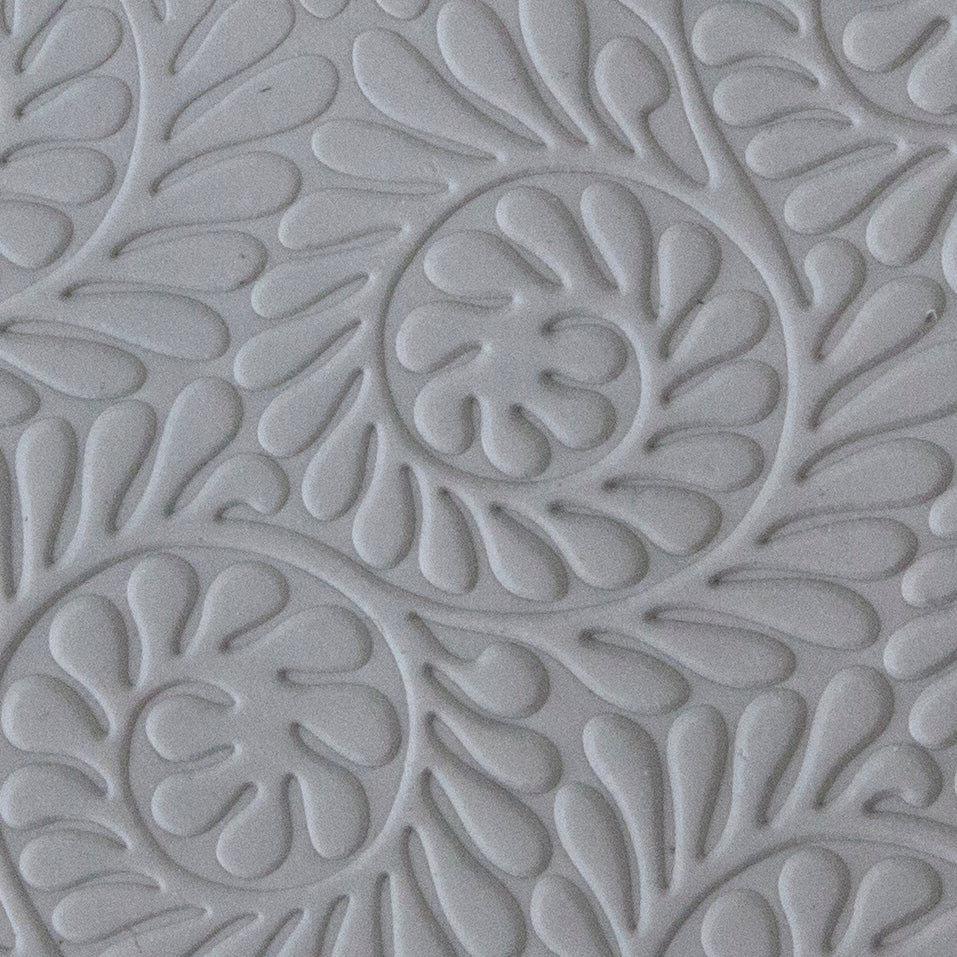 sample in clay of Mega Texture Tile - Fiddlehead Fern Embossed. Use to impress texture in soft clays. Mega Texture Tiles are perfect for projects both large and small. Mega Tiles measure 9-1/4" x 6" and are about 7 times larger than Texture Tiles. These textures are flexible, washable and can be used with any soft clay.