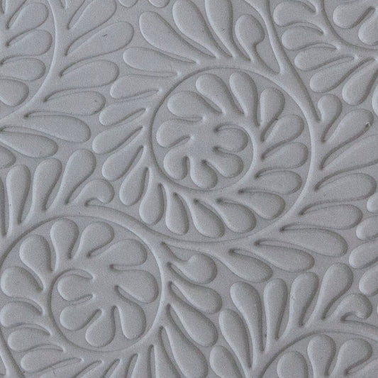 sample in clay of Mega Texture Tile - Fiddlehead Fern Embossed. Use to impress texture in soft clays. Mega Texture Tiles are perfect for projects both large and small. Mega Tiles measure 9-1/4" x 6" and are about 7 times larger than Texture Tiles. These textures are flexible, washable and can be used with any soft clay.