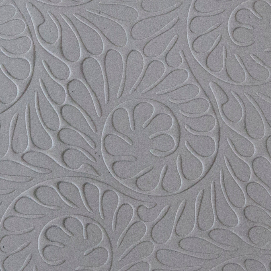 sample in clay of Mega Texture Tile - Fiddlehead Fern. Use to impress texture in soft clays. Mega Texture Tiles are perfect for projects both large and small. Mega Tiles measure 9-1/4" x 6" and are about 7 times larger than Texture Tiles. These textures are flexible, washable and can be used with any soft clay.