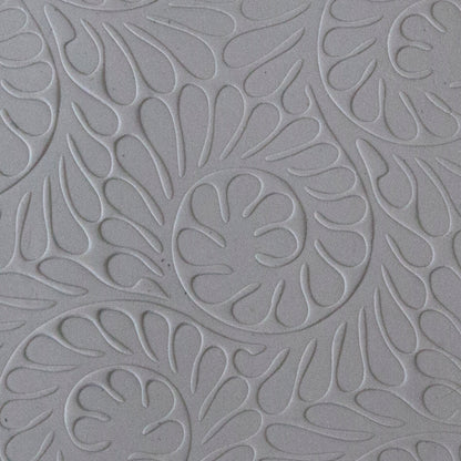 sample in clay of Mega Texture Tile - Fiddlehead Fern. Use to impress texture in soft clays. Mega Texture Tiles are perfect for projects both large and small. Mega Tiles measure 9-1/4" x 6" and are about 7 times larger than Texture Tiles. These textures are flexible, washable and can be used with any soft clay.