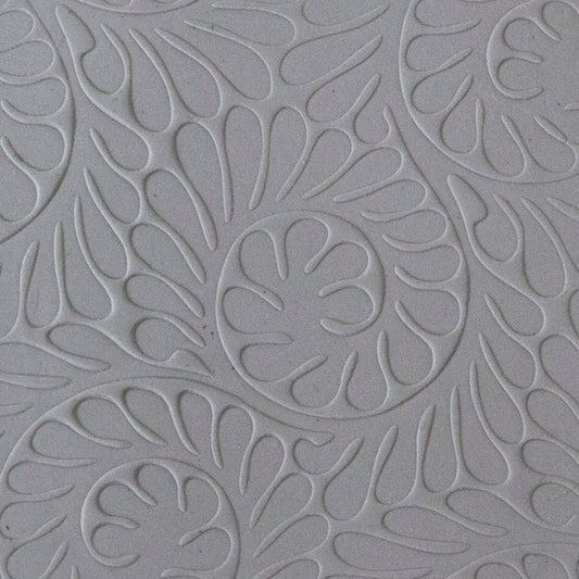 sample in clay of Mega Texture Tile - Fiddlehead Fern. Use to impress texture in soft clays. Mega Texture Tiles are perfect for projects both large and small. Mega Tiles measure 9-1/4" x 6" and are about 7 times larger than Texture Tiles. These textures are flexible, washable and can be used with any soft clay.