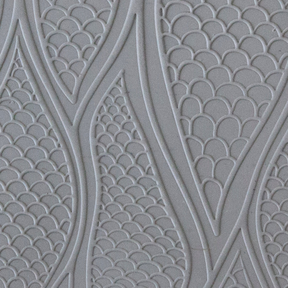 sample in clay Mega Texture Tile - Be Scaled Embossed. Use to impress texture in soft clays. Mega Texture Tiles are perfect for projects both large and small. Mega Tiles measure 9-1/4" x 6" and are about 7 times larger than Texture Tiles. These textures are flexible, washable and can be used with any soft clay.