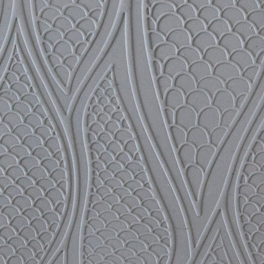 sample in clay Mega Texture Tile - Be Scaled Embossed. Use to impress texture in soft clays. Mega Texture Tiles are perfect for projects both large and small. Mega Tiles measure 9-1/4" x 6" and are about 7 times larger than Texture Tiles. These textures are flexible, washable and can be used with any soft clay.