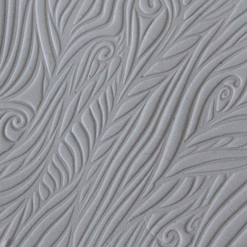 sample in clay of Mega Texture Tile - Blowing in the Wind. Use to impress texture in soft clays. Mega Texture Tiles are perfect for projects both large and small. Mega Tiles measure 9-1/4" x 6" and are about 7 times larger than Texture Tiles. These textures are flexible, washable and can be used with any soft clay.