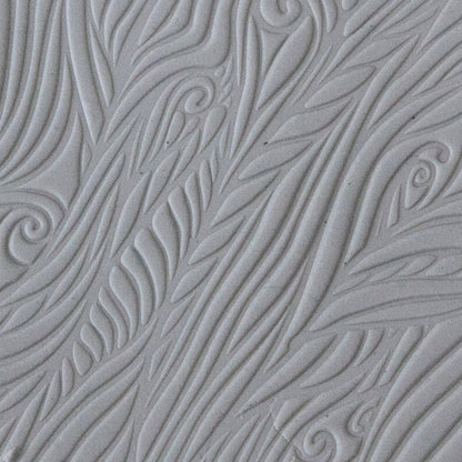 sample in clay of Mega Texture Tile - Blowing in the Wind. Use to impress texture in soft clays. Mega Texture Tiles are perfect for projects both large and small. Mega Tiles measure 9-1/4" x 6" and are about 7 times larger than Texture Tiles. These textures are flexible, washable and can be used with any soft clay.