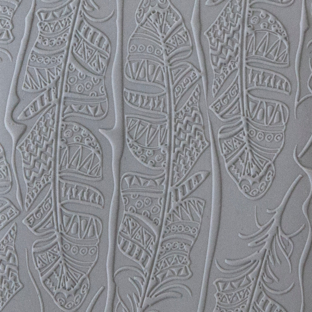 sample in clay of Mega Texture Tile - Tribal Feather Fineline. Use to impress texture in soft clays. Mega Texture Tiles are perfect for projects both large and small. Mega Tiles measure 9-1/4" x 6" and are about 7 times larger than Texture Tiles. These textures are flexible, washable and can be used with any soft clay.
