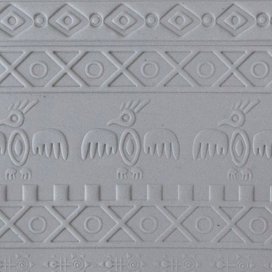 sample in clay of Mega Texture Tile - Tribal Spirits. Use to impress texture in soft clays. Mega Texture Tiles are perfect for projects both large and small. Mega Tiles measure 9-1/4" x 6" and are about 7 times larger than Texture Tiles. These textures are flexible, washable and can be used with any soft clay.