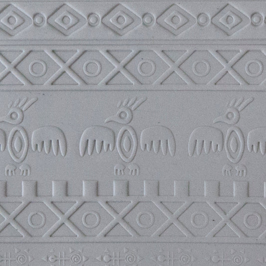 sample in clay of Mega Texture Tile - Tribal Spirits. Use to impress texture in soft clays. Mega Texture Tiles are perfect for projects both large and small. Mega Tiles measure 9-1/4" x 6" and are about 7 times larger than Texture Tiles. These textures are flexible, washable and can be used with any soft clay.