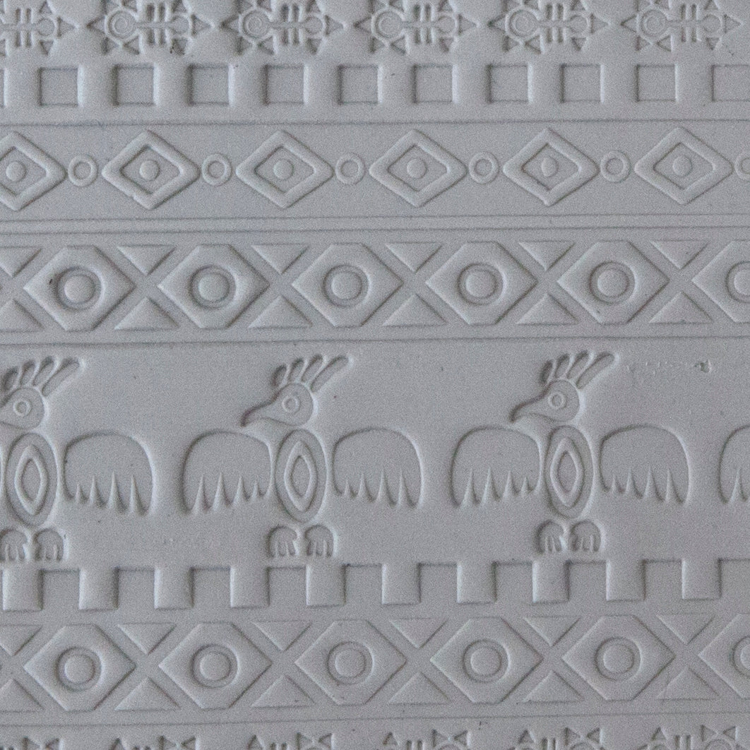 sample in clay of Mega Texture Tile - Tribal Spirits Embossed. Use to impress texture in soft clays. Mega Texture Tiles are perfect for projects both large and small. Mega Tiles measure 9-1/4" x 6" and are about 7 times larger than Texture Tiles. These textures are flexible, washable and can be used with any soft clay.