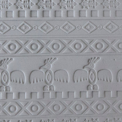 sample in clay of Mega Texture Tile - Tribal Spirits Embossed. Use to impress texture in soft clays. Mega Texture Tiles are perfect for projects both large and small. Mega Tiles measure 9-1/4" x 6" and are about 7 times larger than Texture Tiles. These textures are flexible, washable and can be used with any soft clay.
