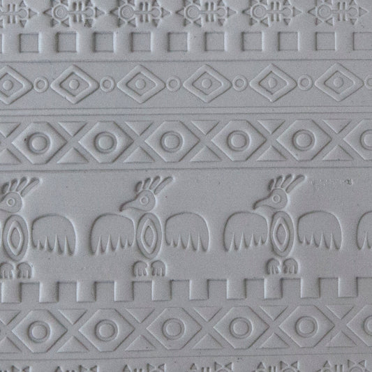 sample in clay of Mega Texture Tile - Tribal Spirits Embossed. Use to impress texture in soft clays. Mega Texture Tiles are perfect for projects both large and small. Mega Tiles measure 9-1/4" x 6" and are about 7 times larger than Texture Tiles. These textures are flexible, washable and can be used with any soft clay.
