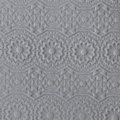 sample in clay of Mega Texture Tile - Celestial. Use to impress texture in soft clays. Mega Texture Tiles are perfect for projects both large and small. Mega Tiles measure 9-1/4" x 6" and are about 7 times larger than Texture Tiles. These textures are flexible, washable and can be used with any soft clay.