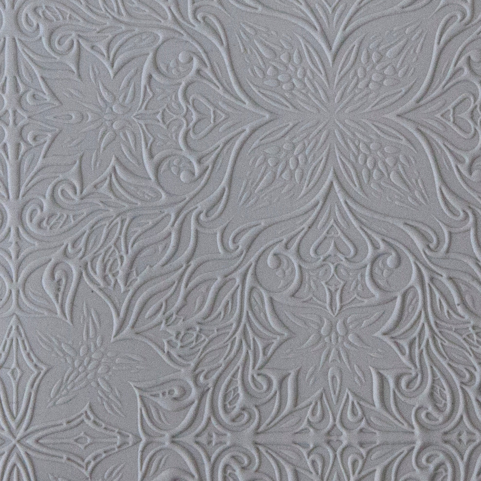 sample in clay of Mega Texture Tile - Woodcut Floral. Use to impress texture in soft clays. Mega Texture Tiles are perfect for projects both large and small. Mega Tiles measure 9-1/4" x 6" and are about 7 times larger than Texture Tiles. These textures are flexible, washable and can be used with any soft clay.