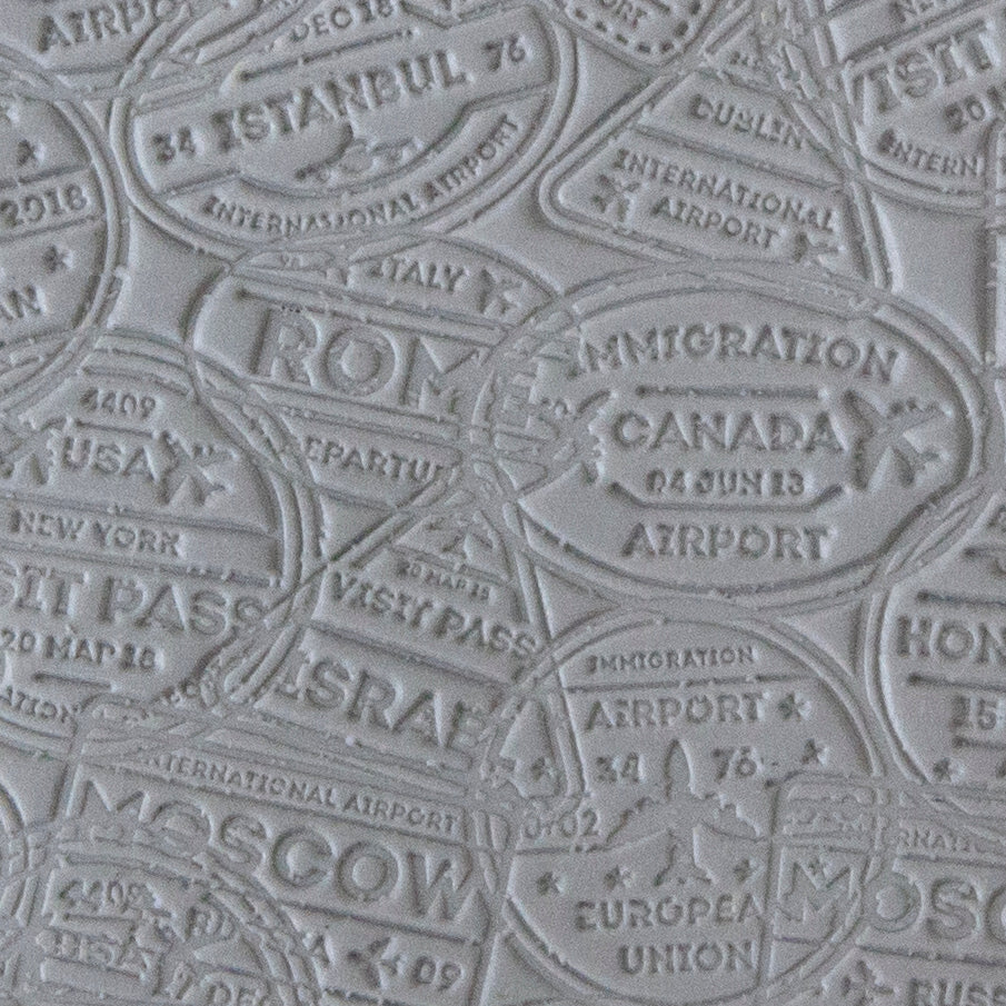 sample in clay of Mega Texture Tile - Bon Voyage. Use to impress texture in soft clays. Mega Texture Tiles are perfect for projects both large and small. Mega Tiles measure 9-1/4" x 6" and are about 7 times larger than Texture Tiles. These textures are flexible, washable and can be used with any soft clay.