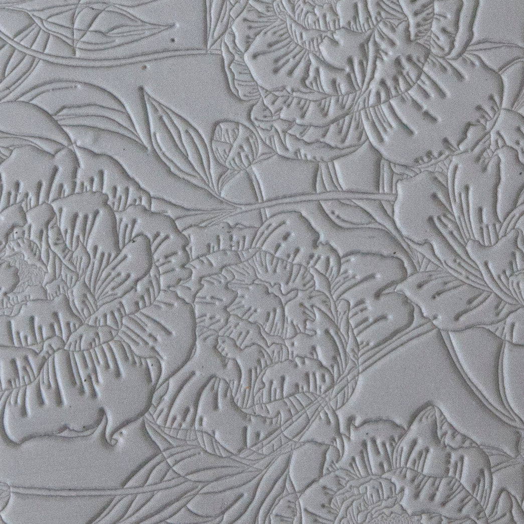 sample in clay of Mega Texture Tile - Peony Wallpaper. Use to impress texture in soft clays. Mega Texture Tiles are perfect for projects both large and small. Mega Tiles measure 9-1/4" x 6" and are about 7 times larger than Texture Tiles. These textures are flexible, washable and can be used with any soft clay.