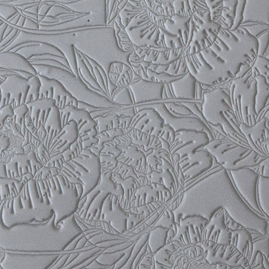 sample in clay of Mega Texture Tile - Peony Wallpaper. Use to impress texture in soft clays. Mega Texture Tiles are perfect for projects both large and small. Mega Tiles measure 9-1/4" x 6" and are about 7 times larger than Texture Tiles. These textures are flexible, washable and can be used with any soft clay.