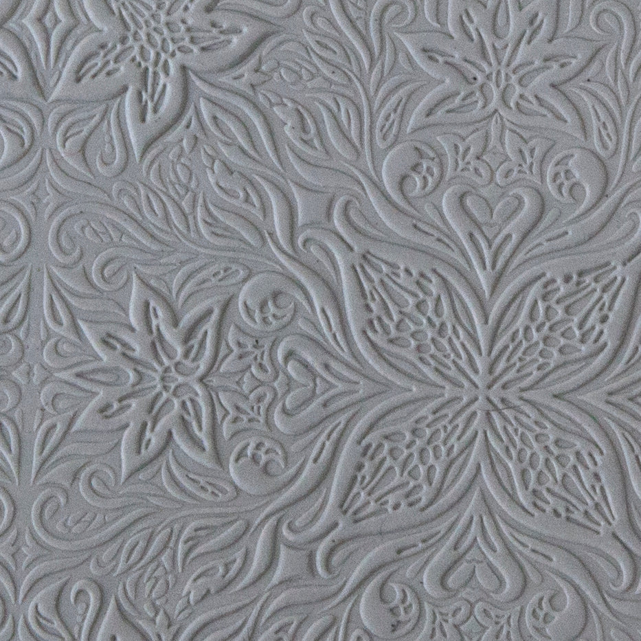 sample in clay of Mega Texture Tile - Woodcut Floral Embossed. Use to impress texture in soft clays. Mega Texture Tiles are perfect for projects both large and small. Mega Tiles measure 9-1/4" x 6" and are about 7 times larger than Texture Tiles. These textures are flexible, washable and can be used with any soft clay.