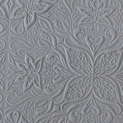sample in clay of Mega Texture Tile - Woodcut Floral Embossed. Use to impress texture in soft clays. Mega Texture Tiles are perfect for projects both large and small. Mega Tiles measure 9-1/4" x 6" and are about 7 times larger than Texture Tiles. These textures are flexible, washable and can be used with any soft clay.