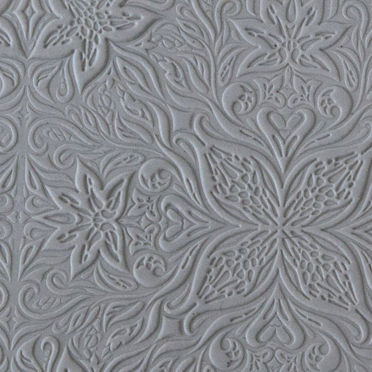 sample in clay of Mega Texture Tile - Woodcut Floral Embossed. Use to impress texture in soft clays. Mega Texture Tiles are perfect for projects both large and small. Mega Tiles measure 9-1/4" x 6" and are about 7 times larger than Texture Tiles. These textures are flexible, washable and can be used with any soft clay.