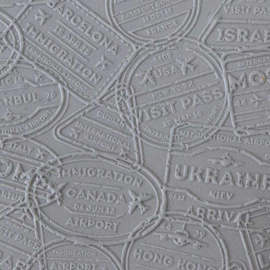 sample in clay of Mega Texture Tile - Bon Voyage Embossed. Use to impress texture in soft clays. Mega Texture Tiles are perfect for projects both large and small. Mega Tiles measure 9-1/4" x 6" and are about 7 times larger than Texture Tiles. These textures are flexible, washable and can be used with any soft clay.