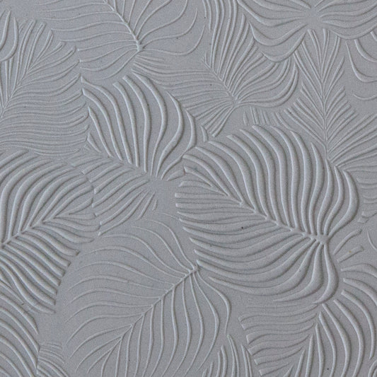 sample in clay of Mega Texture Tile - In the Tropics. Use to impress texture in soft clays. Mega Texture Tiles are perfect for projects both large and small. Mega Tiles measure 9-1/4" x 6" and are about 7 times larger than Texture Tiles. These textures are flexible, washable and can be used with any soft clay.