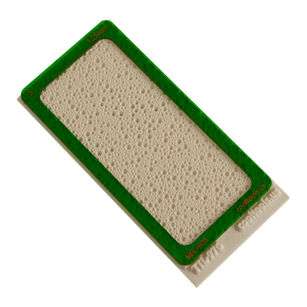 5 card green plastic mini clay thickness rolling frame on top of beige rubber texture tile