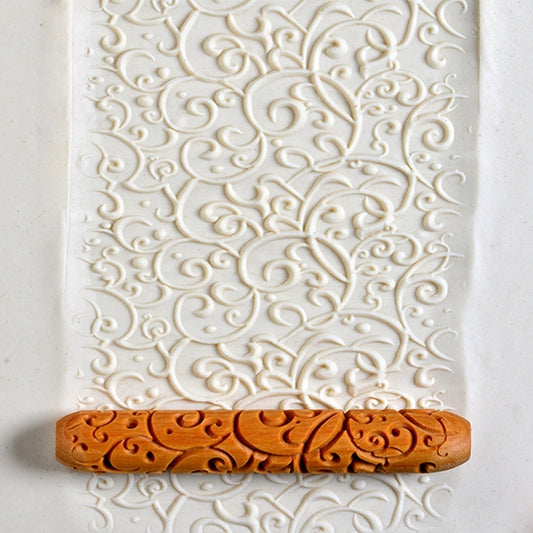 Wooden Hand Roller - Curlicue rolled into white clay