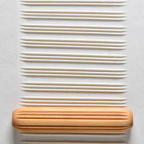 Large Wooden Hand Roller - Lines and Spaces rolled into clay