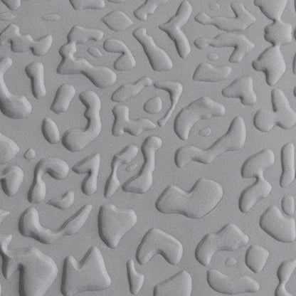 Texture Tile - Jaguar Print Embossed sample rolled into gray polymer clay