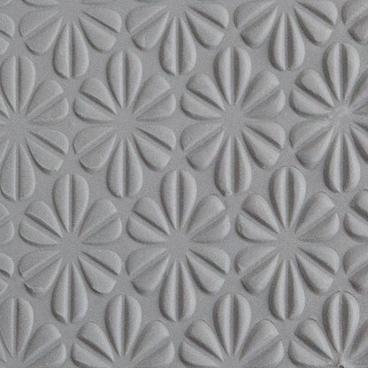Texture Tile - Retro Daisies Embossed sample rolled into gray polymer clay