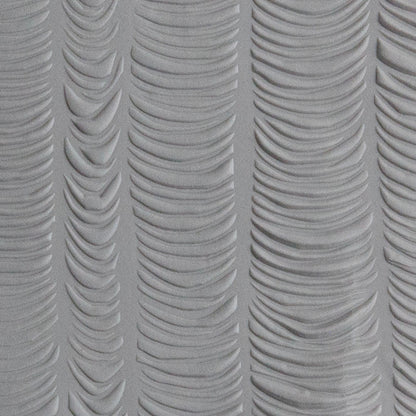 Texture Tile - Changing Tides sample rolled into gray polymer clay