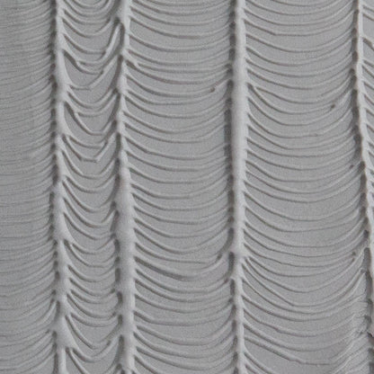Texture Tile - Changing Tides Embossed sample rolled into gray polymer clay