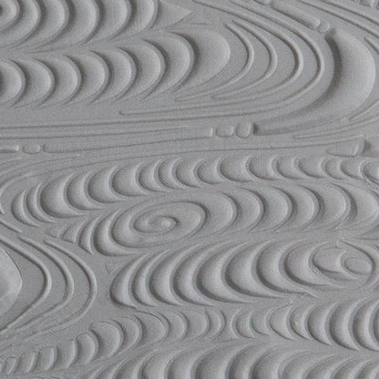 Texture Tile - A River Runs Through sample rolled into gray polymer clay