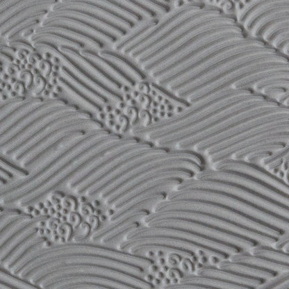 Texture Tile - High Surf sample rolled into gray polymer clay