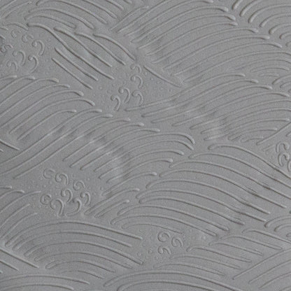 Texture Tile - High Surf Embossed sample rolled into gray polymer clay