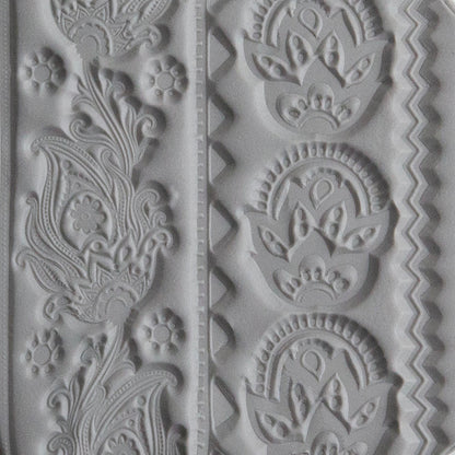Texture Tile - Dancing Print sample rolled into gray pollymer clay