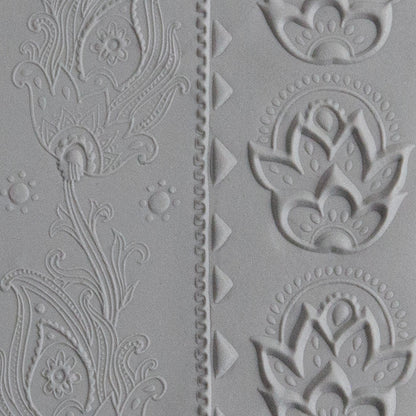 Texture Tile - Dancing Print Embossed sample rolled into gray polymer clay