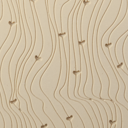 Texture Tile - Hearts on the Line Fineline. Beige Texture Tiles are flexible, washable and can be used with any soft clay. Spritz with CoolSlip or dust on Dry Powder Release for stick-free impressions when using metal clay and polymer clay.