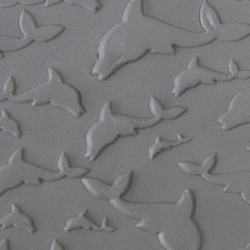 Texture Tile - Flying Dolphins Embossed sample rolled into clay