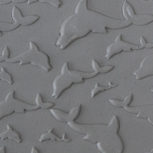 Texture Tile - Flying Dolphins Embossed sample rolled into clay