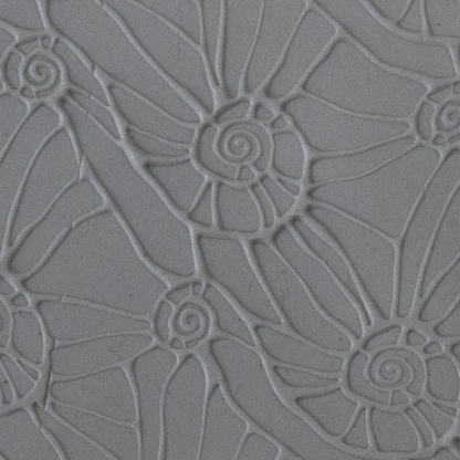 Texture Tile - Snail Parade Embossed sample rolled into clay
