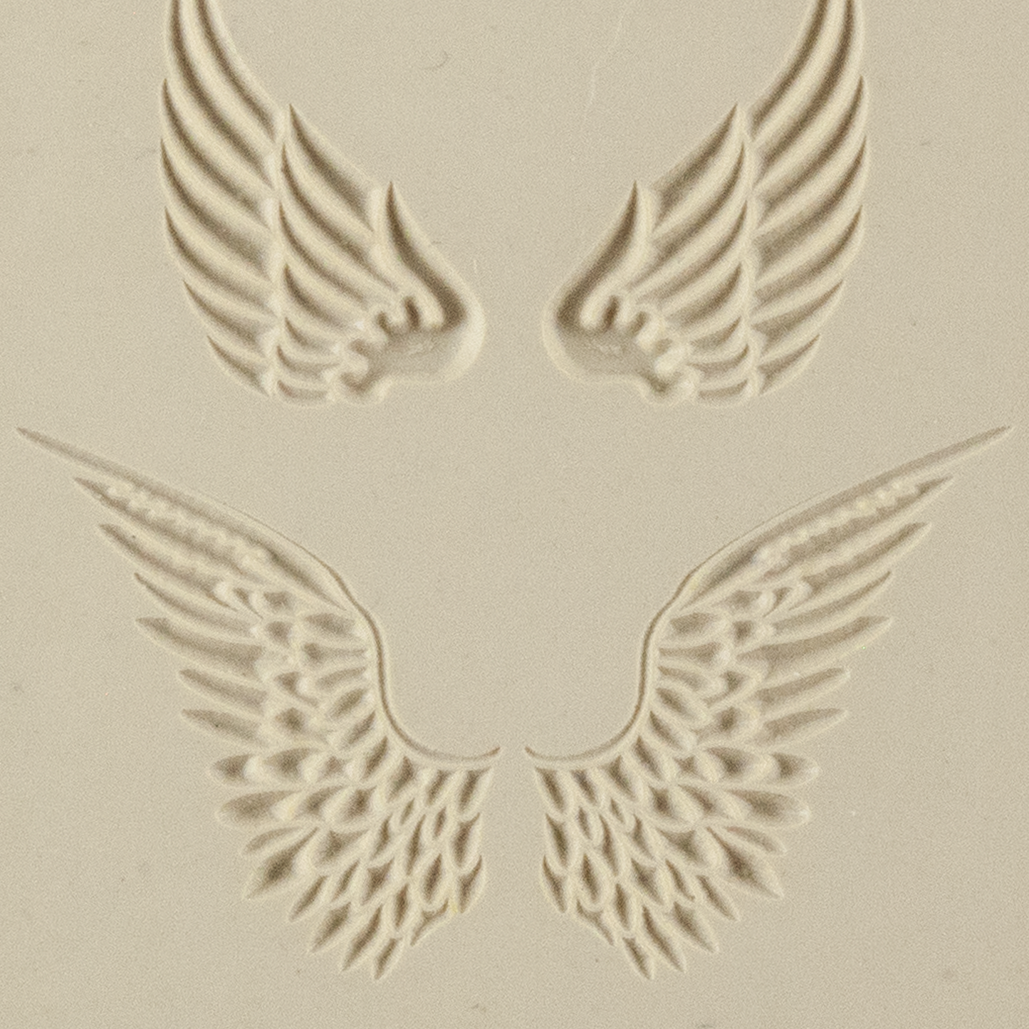 Texture Tile - Angel Wings Embossed. Beige Texture Tiles are flexible, washable and can be used with any soft clay. Spritz with CoolSlip or dust on Dry Powder Release for stick-free impressions when using metal clay and polymer clay.