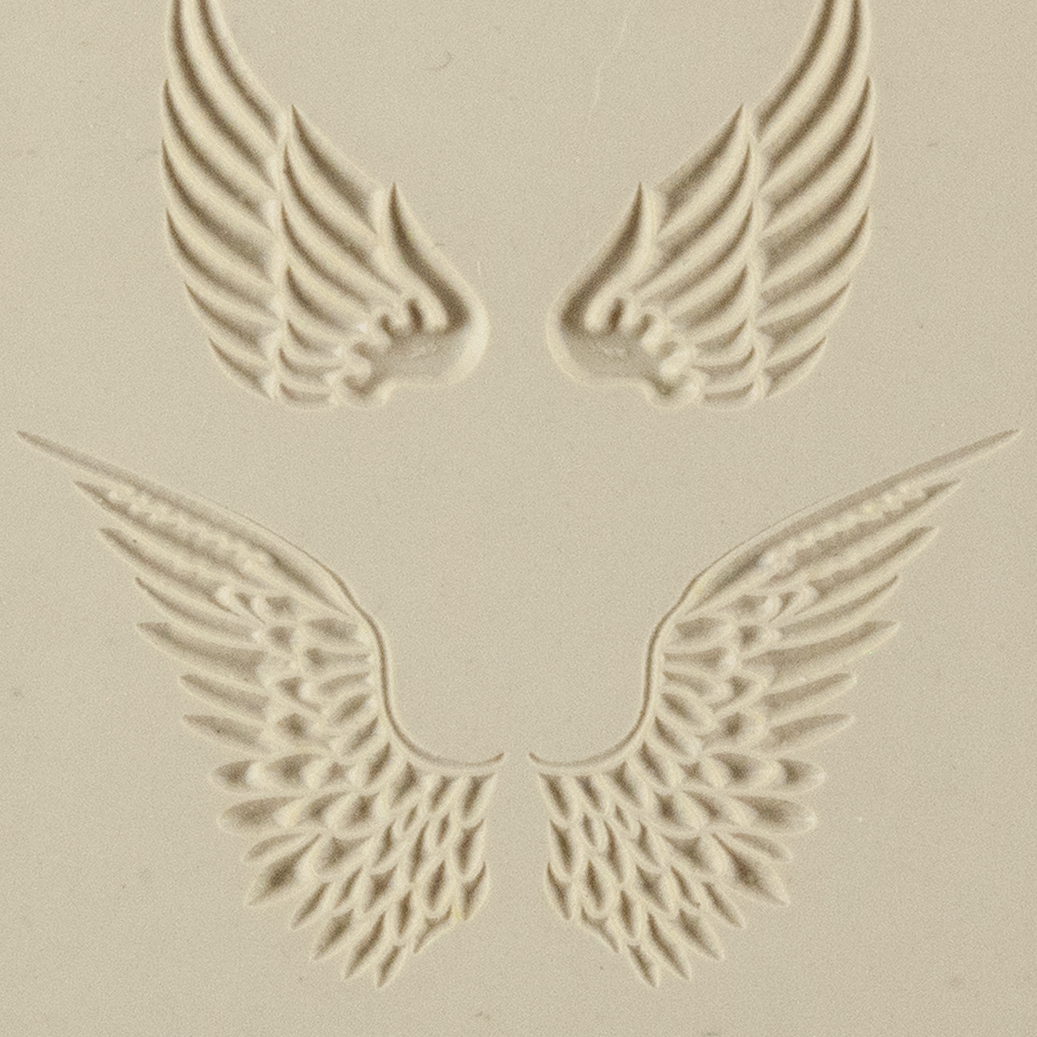 Texture Tile - Angel Wings Embossed. Beige Texture Tiles are flexible, washable and can be used with any soft clay. Spritz with CoolSlip or dust on Dry Powder Release for stick-free impressions when using metal clay and polymer clay.