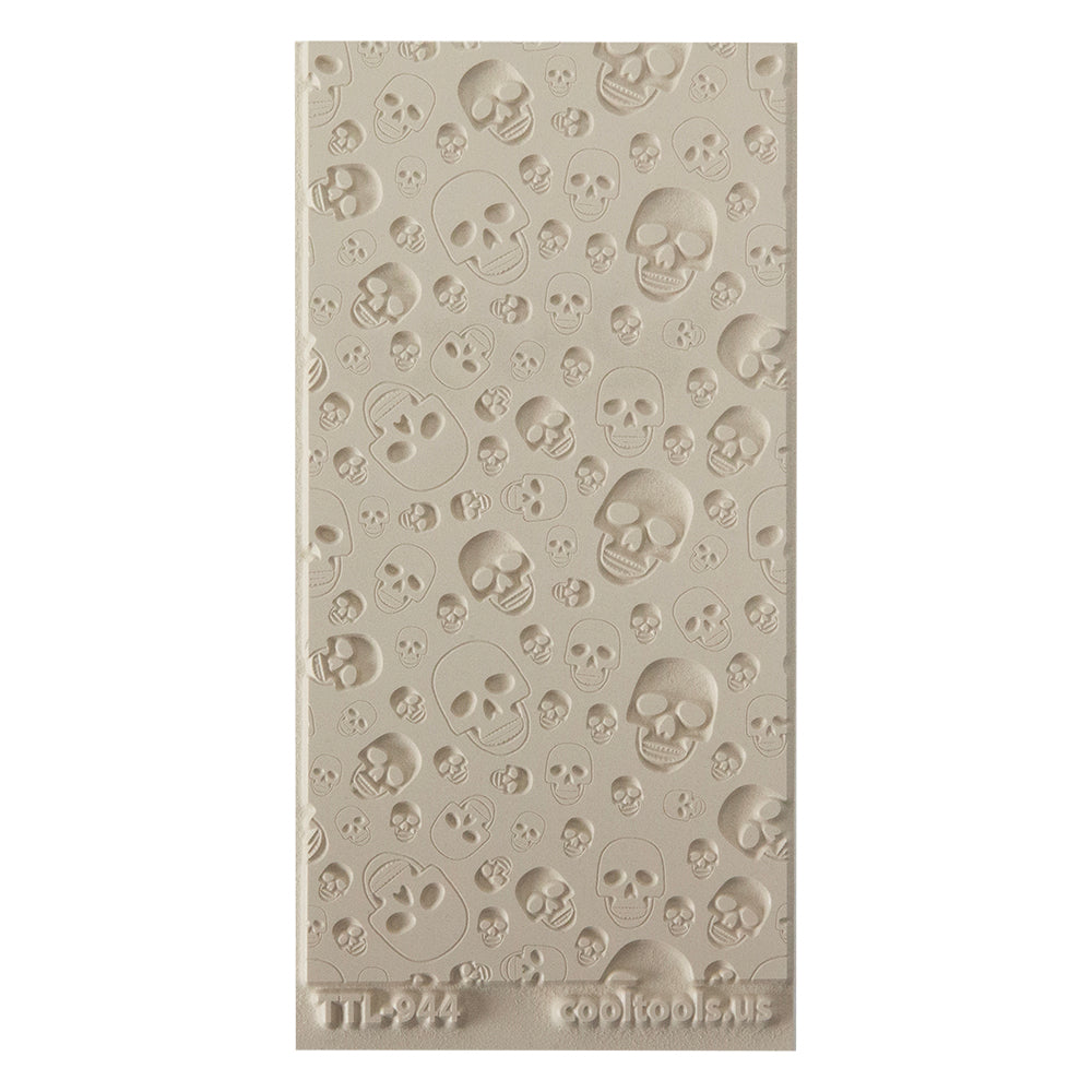 Texture Tile - Skulls Embossed. Beige Texture Tiles are flexible, washable and can be used with any soft clay. Spritz with CoolSlip or dust on Dry Powder Release for stick-free impressions when using metal clay and polymer clay.