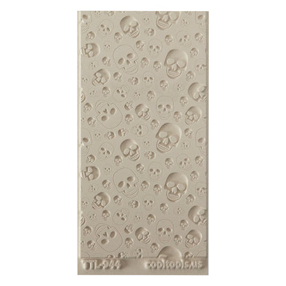 Texture Tile - Skulls Embossed. Beige Texture Tiles are flexible, washable and can be used with any soft clay. Spritz with CoolSlip or dust on Dry Powder Release for stick-free impressions when using metal clay and polymer clay.